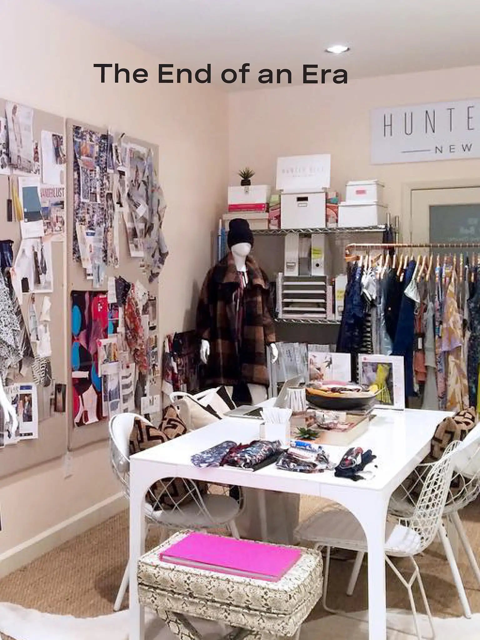 Room with clothing racks, a table with items, and a 'The End of an Era' sign.
