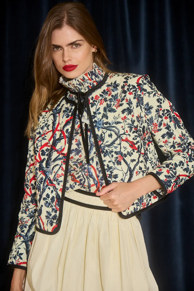 The Atwood Jacket is a quilted jacket with a crew neckline, long sleeves, and velvet ribbon trim.