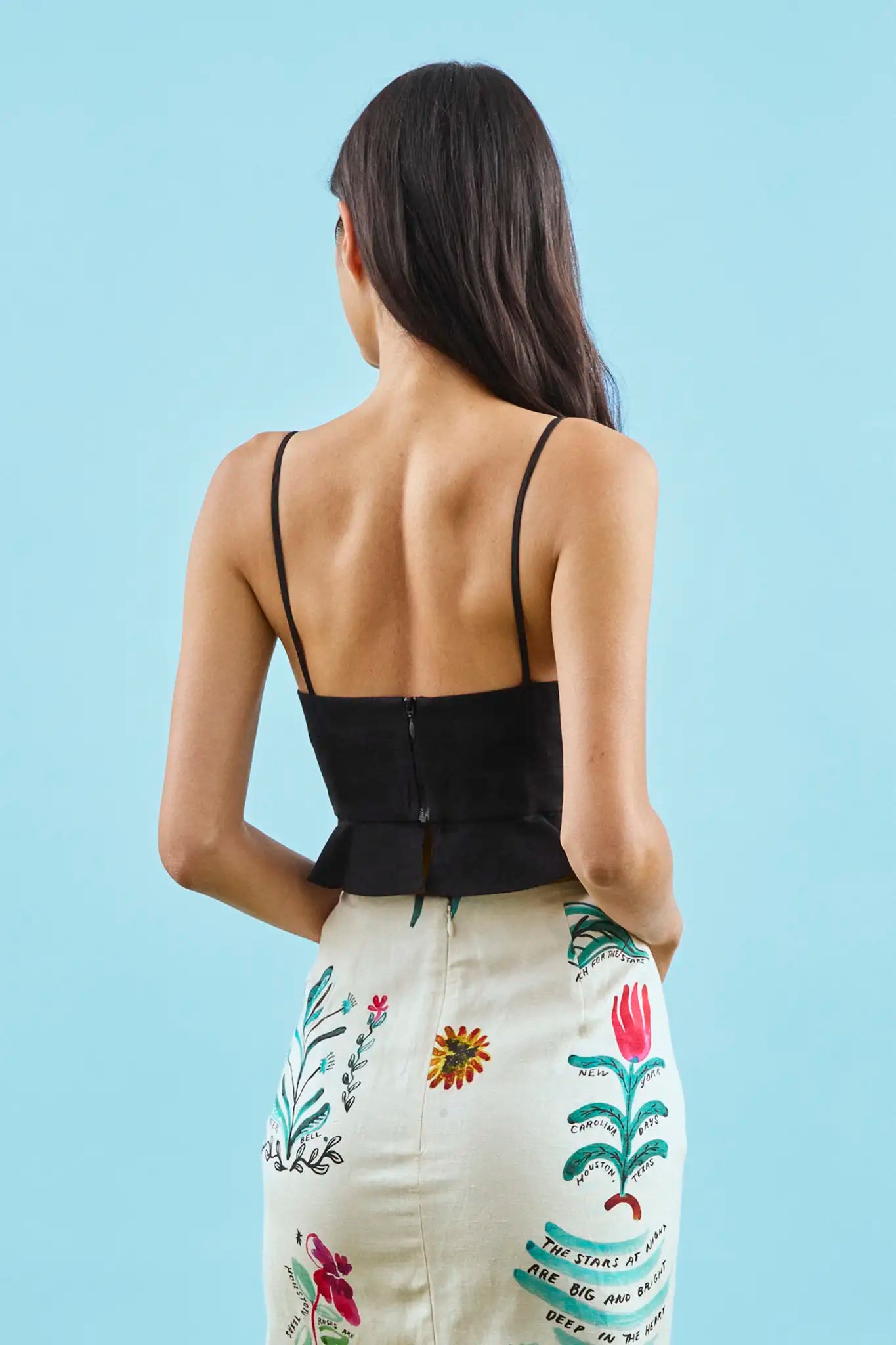 The Chrissy Top is a sleek spaghetti-strap camisole with a seamed bust and a back zipper.