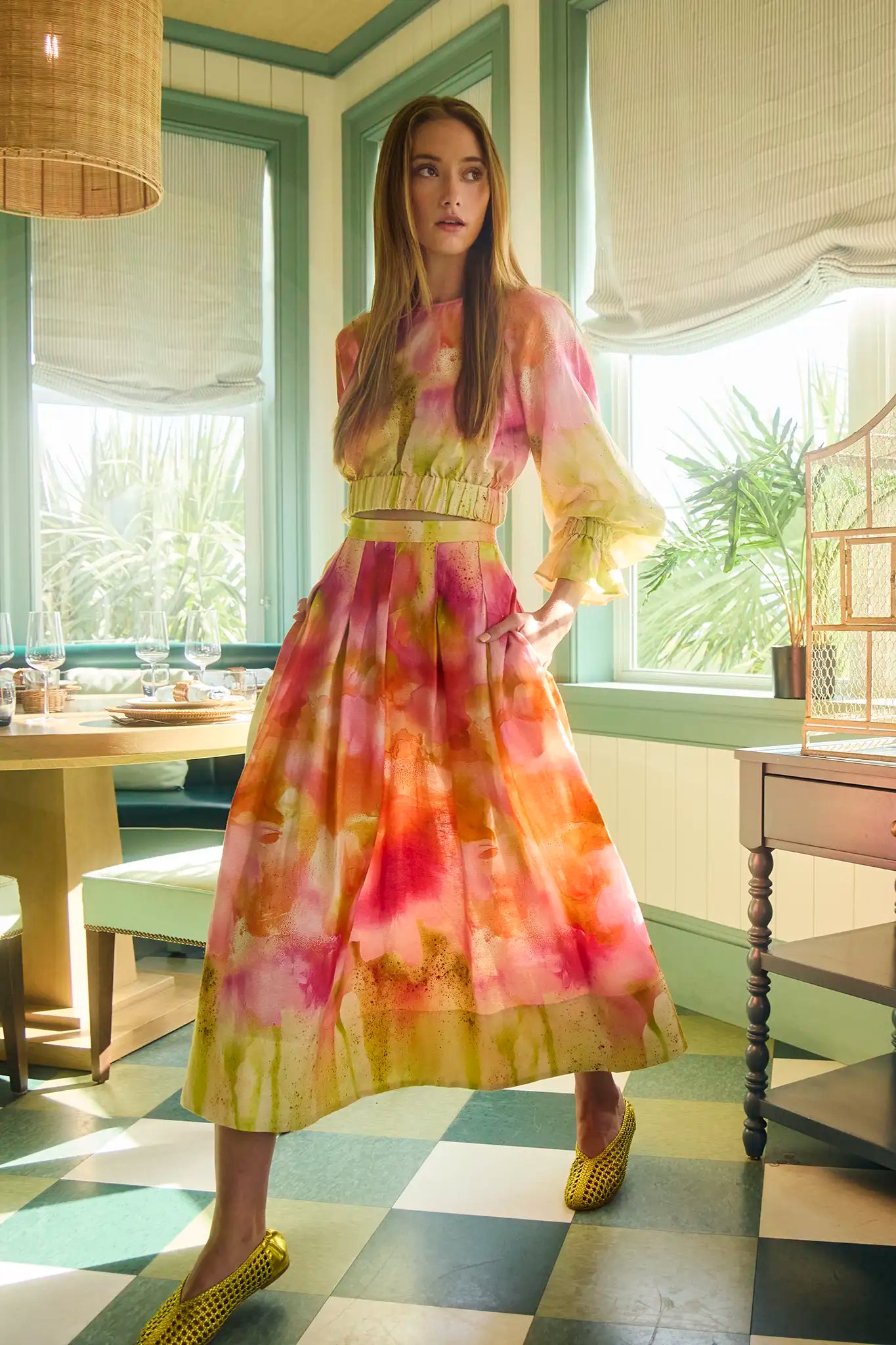 A pleated full skirt in a colorful print with a matching long sleeve top
