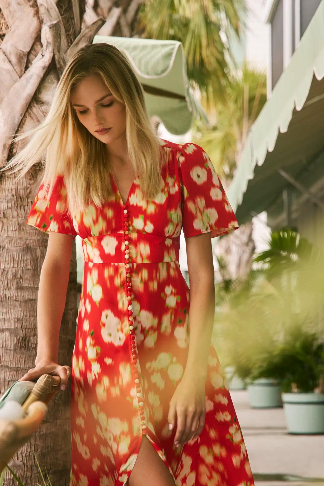An A-line fitted waist midi dress in an orange and yellow print