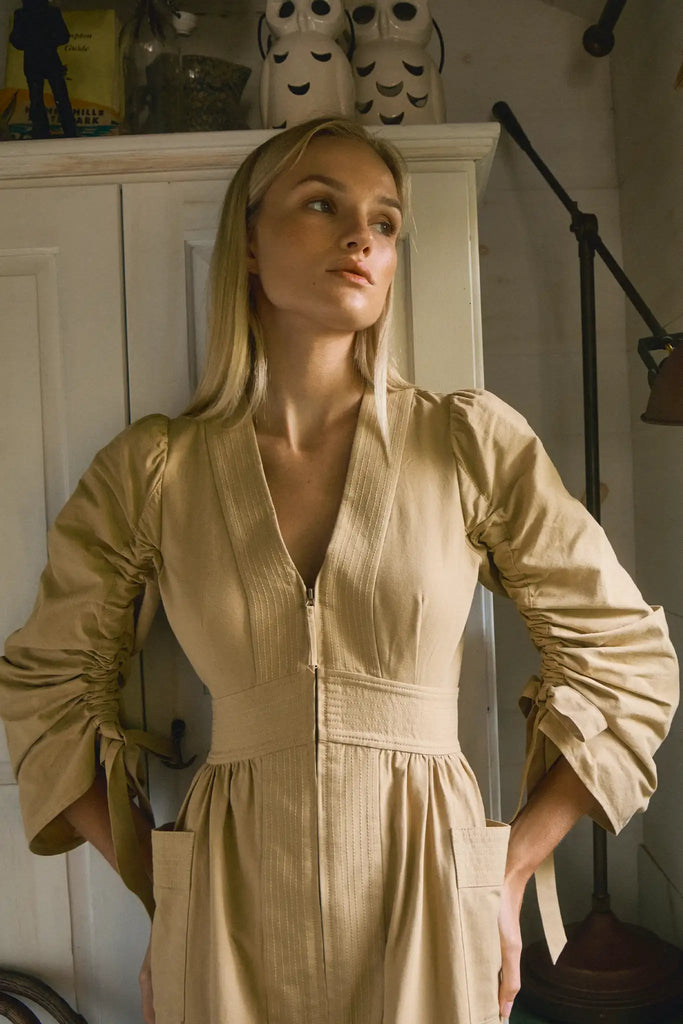 V-neck midi dress with a fitted bodice, full skirt, elbow-length sleeves finish with ties.