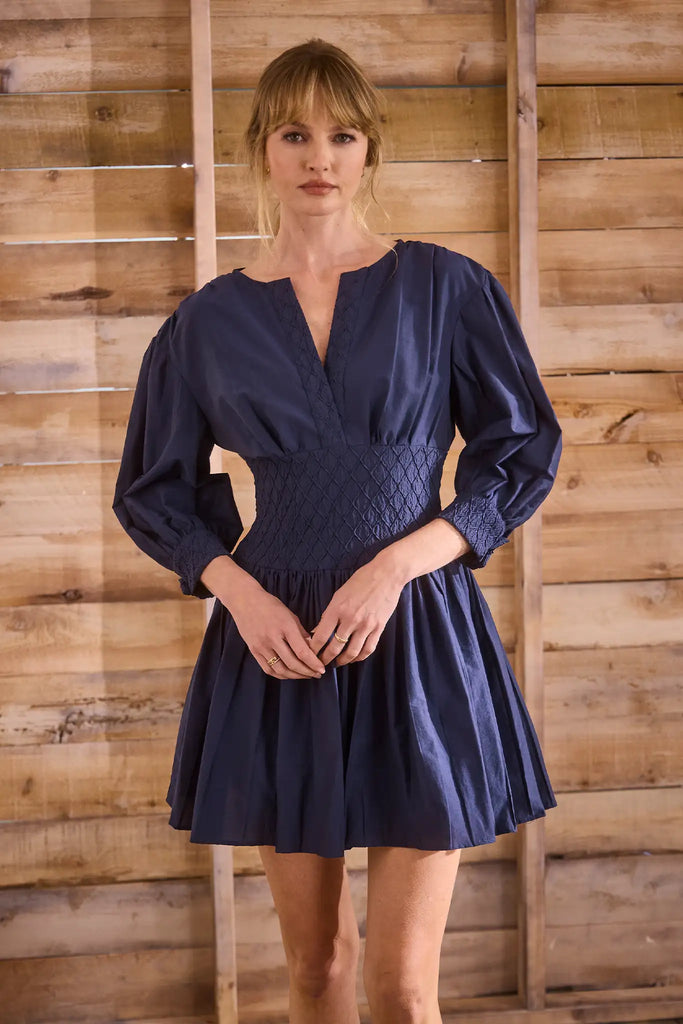 Navy diamond-smocked novelty shirting fabric with a soft V effect and blouson sleeves.